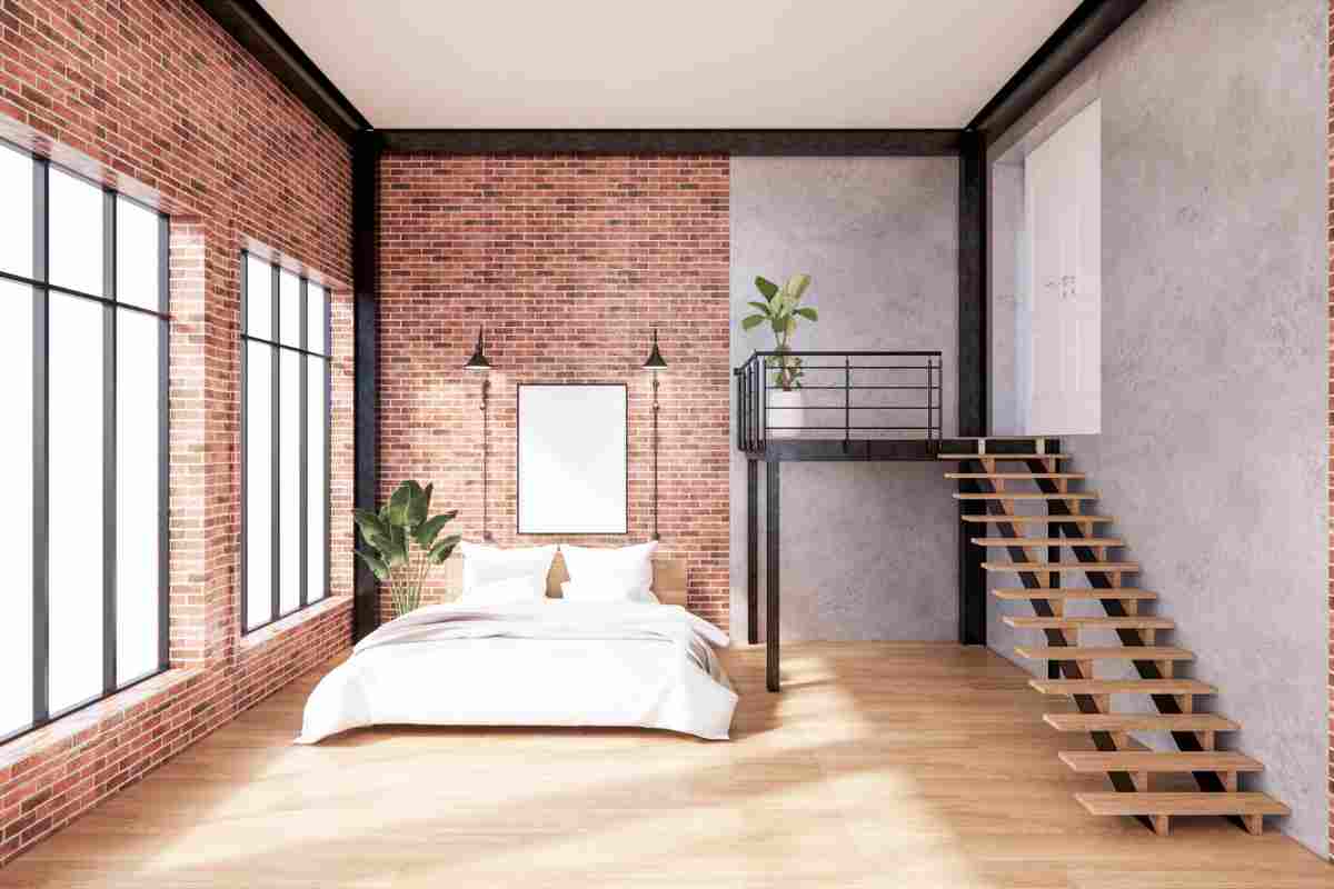 camera da letto con pareti con mattone a vista