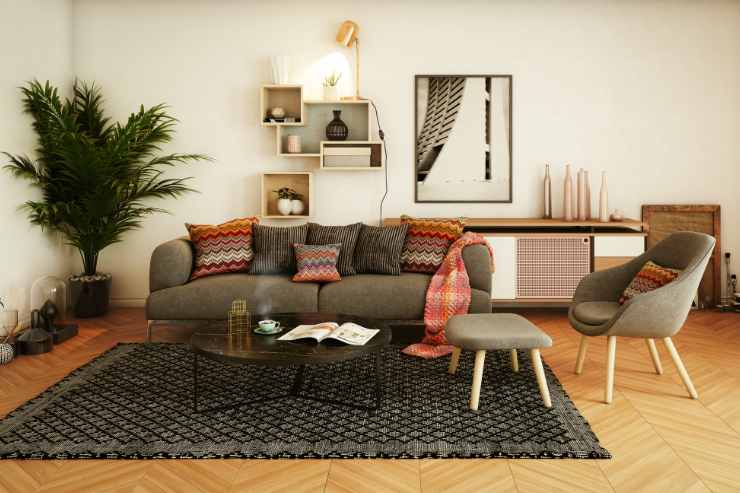 soggiorno con divano, cuscini decorativi e copertina