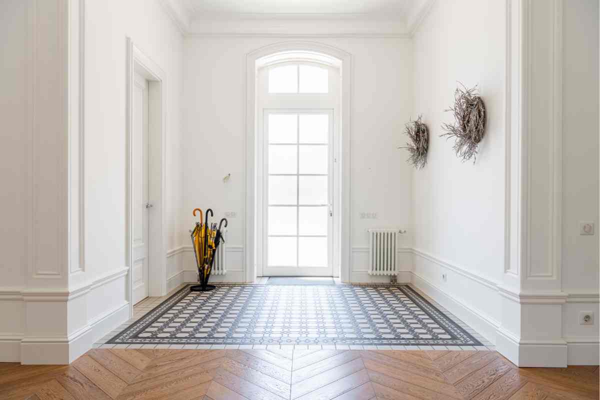 Pavimento parquet e piastrelle in un ingresso luminoso