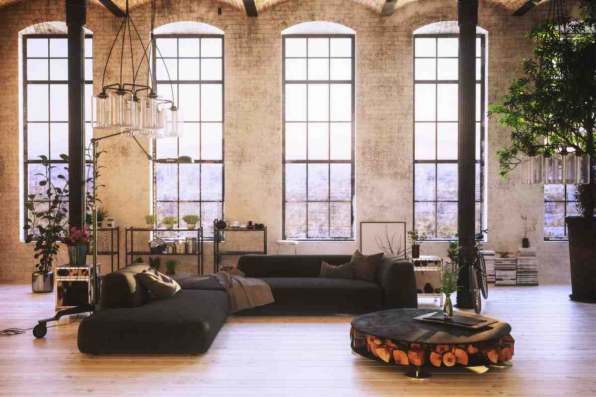 loft arredato con angolo salotto, tavolino e mobili minimal